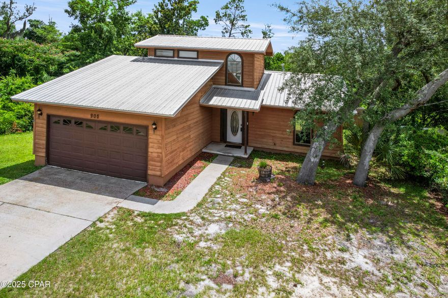 Lynn Haven Home on ½ Acre with Pool & Development Potential!  Tucked away on a quiet dead-end street, this 3 bedroom, 2.5 bath PLUS office home sits on a 150x150 lot, which could offer the potential for a lot split for future investment opportunity (or enjoy added privacy). The open-concept main level features a charming kitchen with granite countertops, abundant cabinetry, and ample prep space for cooking and entertaining. The master suite, a second bedroom, and a full bath are located on the first floor, while upstairs you'll find a third bedroom with a private balcony, a half bath, and an office. The 2 car garage provides convenient storage and parking. Outside, there is an in-ground pool (needs a new liner and cleaning), mature trees, a covered back porch, and a spacious patio and deck area, perfect for relaxing or entertaining. Located near great schools, parks, shopping, and just minutes from the public boat ramp, this property offers charm, location, and potential - perfect for a little vision and creativity!