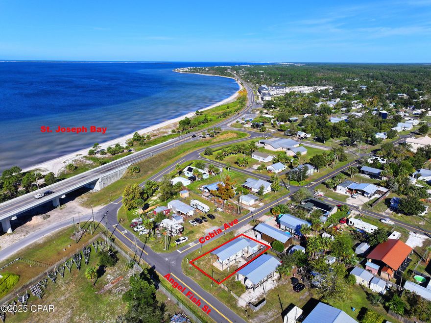 Charming Coastal RV Retreat!!  Discover the perfect blend of comfort and coastal convenience at 215 Angel Fish Street, ideally located just minutes from Downtown Port St. Joe and St. Joe Bay. This 0.11-acre corner lot features a covered pole barn with concrete pad, fully insulated and finished outbuilding with a living area, half bath and a sitting deck. This property is ideal for your RV, boat, or beach toys, and comes equipped with electric, water, and sewer hookups—ready for your next Gulf getaway.  Everything is done for you - RV is included in this wonderful opportunity.  Enjoy peaceful mornings with Bay breezes and easy access to public boat launches, beaches, and the Intracoastal Waterway. The property is fully fenced for privacy, with beautiful tropical landscaping and plenty of room for entertaining or future expansion. Whether you're looking for a vacation retreat, investment rental, or full-time coastal living, this property offers endless potential in a quiet, golf-cart-friendly community.  Located in the Highland View neighborhood—no HOA, close to local seafood markets, marinas, and just a short drive to Cape San Blas and Mexico Beach. Bring your RV or your builder and make this your slice of paradise on the Forgotten Coast!