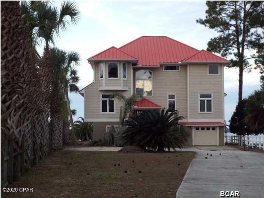 North Bay water front home with three levels.  The lower level is unfinished and includes the garage.  The second level has a spacious Great room, open Kitchen, two Bedrooms and two full baths.  The third level has the Master Bedroom/Bath, two additional bedrooms and a full bath.  There are balconies on both the second and third floors that run along the full back of the home with amazing views of the Bay.  Home has extensive damage from Hurricane Michael and is being sold in its AS IS condition.