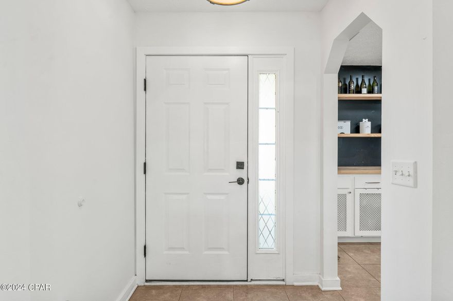 Welcome to this updated and well-maintained home nestled in Lynn Haven. This 3-bedroom, 2-bathroom residence offers a blend of modern upgrades and comfortable living. Step inside to discover recent improvements, including a new roof and AC in 2019, and new storm-rated windows in 2020. The kitchen has been tastefully updated with new cabinets, butcher block countertops, stainless steel appliances, and a charming farm sink. Both bathrooms have also received stylish renovations. Inside, you'll find commercial-grade hardwood bamboo floors and oversized tiles, providing durability and a touch of elegance. The living room features vaulted ceilings, creating an airy atmosphere, and opens up to a spacious screened porch, perfect for relaxing or entertaining. The bedrooms are arranged in a practical split floor plan, with the master bedroom boasting two closets and an ensuite bath. Two additional bedrooms share a well-appointed bathroom. With its thoughtful upgrades and inviting spaces, this home offers turnkey convenience and a warm atmosphere, inviting you to make it your own. Set your appointment today!