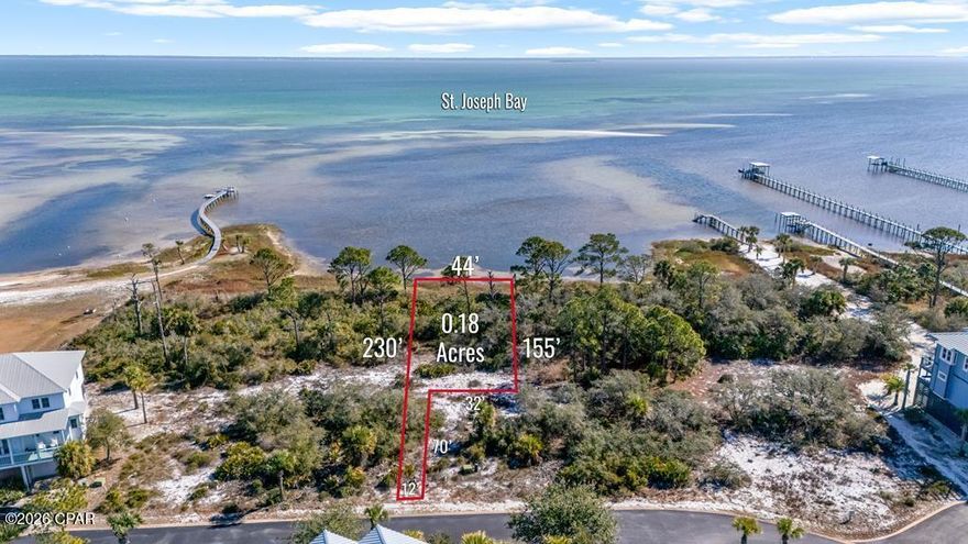 BAY FRONT HOMESITE in Ovation - one of the area's most prestigious gated communities on North Cape San Blas. This exceptional bay-to-gulf neighborhood stretches from the sugar-white sands of the Gulf to the calm Bay waters, providing exclusive access to both. Ovation offers an unmatched collection of resort-style amenities. The Bay Club features an infinity-edge pool, fitness center, hot tub, fire pits, and scenic day docks overlooking the bay ideal for boating, kayaking, or simply unwinding by the water. Tennis and pickleball courts, and inviting gathering areas enhance the community's relaxed yet upscale atmosphere. On the Gulf side, residents enjoy a second pool and bathhouse with private boardwalks leading directly to miles of pristine beach to watch the sun go down and try to catch that green flash! Meticulously maintained landscaping and a minimum build requirement of 2,000 square feet ensure a cohesive and elevated neighborhood feel. Conveniently located near St. Joseph Peninsula State Park, home to the named #1 Beach in America, for miles of pristine shoreline, nature trails, and outdoor adventure. This homesite presents a opportunity to build between the Gulf and the Bay along Florida's Forgotten Coast. Perfectly positioned along the tranquil waters of St. Joseph Bay, offering sweeping views, unforgettable sunrises, and a lifestyle that blends refined coastal elegance with natural beauty. No timeline to build.