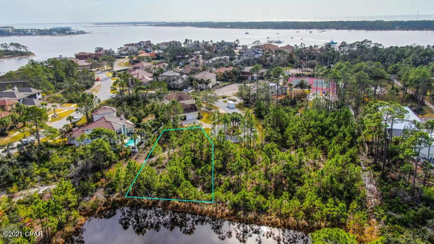 Build your dream home in the exclusive gated community of Finisterre! This lot is located at the end of a cul-de-sac, with a pond directly behind the property for ultimate privacy. Finisterre offers the security of a gated community, two tennis courts, a basketball court, playground and community dock. It is located with in walking distance to some of the most popular restaurants on the east end of Panama City Beach and a short drive to the worlds most beautiful beaches.