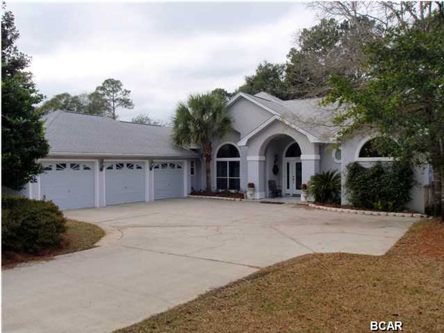 Welcome to 2407 Willow Lane! This home is tucked away in the ''middle'' of the lovely Panama City Country Club. Here, you'll have privacy, signature golf course holes/fairways in the front and back, and you'll be lake front! It doesn't get much better than that! This lovely 4 BR/3 BA, split floor plan home has been very well kept and has so much to offer! As you enter the front door, you are met with a lovely formal sitting area and formal dining room. This home is great for entertaining, as it offers an open kitchen/family room/wet bar, surround sound, and french doors that open to an in-ground, grecian-style pool and veranda. The kitchen has beautiful granite countertops and tile backsplash, and it offers stainless steel appliances. The family room will be cozy on those cool night