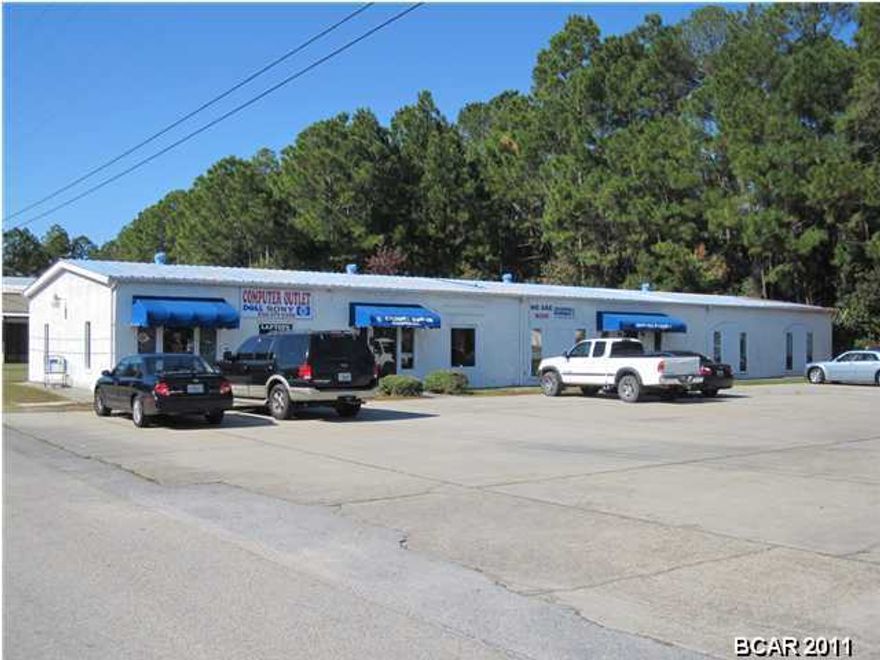 Super prime, high visibility, high traffic location at the northwest corner of Hwy 77 & Peachtree Drive, having 144+/- Feet on Hwy 77, by 201+/- Feet on Peachtree Drive (29,229+/- SF - .67+/- acres). The site is across Highway 77 from the primary entrance to a new WalMart SuperCenter. Highway 77 is a four (4) lane with median cut, turn lanes and traffic signal at the site. The traffic count on Hwy 77 is 28,546 (2014 FDOT). There is a 5,250+/- SF Office Building on the property with two tenants, a Real Estate Office (4,450+/- SF) and a Computer Store (800+/- SF). Existing leases may be terminated by Landlord with 150 days written notice. Marketing and Information Package, tenant summary, and income and expense summary is available upon request. This site is located in the center of all major commercial activity (retail, restaurants, banks, grocery stores, drug stores etc.), and a high concentration of residential including a new 192+/- unit apartment complex (Pinnacle At Hammock Square).