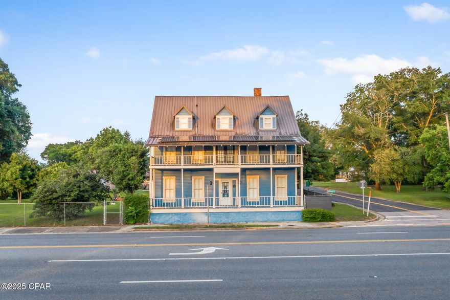 The historic Satsuma Hotel right in the heart of downtown Alford, Fl.  is a unique 5,076 sq ft property on a .64-acre lot, grandfathered in as a commercial/residential multi-use building. Currently used as a private residence, with 18+ rooms, including 8 bedrooms and 3 full modern baths and 2 half baths, this versatile space is ideal for use as a boutique inn, event venue, private residence, or live/work setup. Inside, you'll find heart pine floors, restored original cabinetry, a large entertainment hall (15'x46') with antique sliding doors, a spacious pantry, laundry room, modern stainless appliances, and negotiable vintage kitchen pieces. Notable upgrades include a tin roof (2018), solar panels with Tesla battery backup (2020), central HVAC on each floor, Berber commercial carpet, bead board insulation, shotgun-style hallways, and 11' ceilings. The third floor serves as an art studio with additional attic storage potential. Federal grants have funded major infrastructure improvements including a commercial sewage system (to be completed Sept 2025), a city water tower and modern water system (completed Dec 2024), freshly paved roads, and updated street signage. Outdoor features include a fenced yard with two electric gates, a 2-car garage, three porches, ample guest parking, an equipment shed with attached guest bath, and an exterior staircase with a wench for lifting items to upper floors. Make an appointment today to see all this beautiful property has to offer.