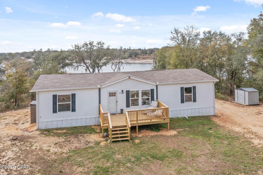 Welcome to peaceful lake living! This adorable 2023 farmhouse-style home on River Lake offers a charming blend of modern finishes and relaxed country style in a beautiful lakefront setting. Featuring 3 bedrooms and 2 bathrooms, the home boasts an inviting open living, dining, and kitchen layout that creates a bright and welcoming space for everyday living and entertaining. The beautiful kitchen is a standout with a large island and breakfast bar, stylish two-toned cabinetry, and a dedicated coffee bar area, combining both functionality and farmhouse charm. The living room features a custom detailed accent wall that adds warmth and character, while vinyl plank flooring throughout provides durability and a clean, modern look. The spacious master suite includes a walk-in closet and a private bathroom with double sinks and a tub/shower combo, offering comfort and convenience. Enjoy the outdoors with a large uncovered front porch perfect for relaxing, a covered back porch overlooking the water, and a 24x24 barn complete with a roll-up door, providing excellent space for storage, hobbies, or equipment. With waterfront access to River Lake, this property offers the ideal setting to enjoy the peaceful beauty of lakefront living.