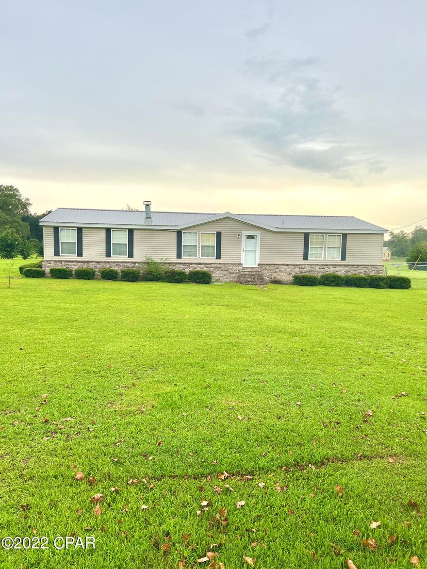 Check out this 2112 square foot 3/2 doublewide with lots of upgrades!  This home sits on 2 acres and was lovingly adorned with brick skirting, ceramic tile, textured joint-free walls, and new bedroom carpet.  It is squeaky clean and meticulously maintained.  Hosting gatherings won't threaten the cleanliness of the main residence since the 800 sq foot heated and cooled man cave with its full kitchen and bath and three large televisions is the perfect spot to entertain.  The cedar woodwork is reminiscent of a mountain cabin and the stained concrete floors are both beautiful and low maintenance.  Like the cherry on a sundae, the 48x60 open pole barn completes this country homestead.
