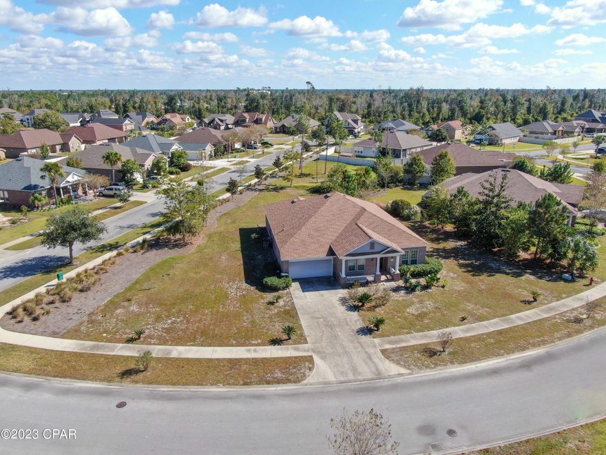 Check out this beautiful new listing in the highly sought-after Hawks Landing community! The Hawks Landing neighborhood is conveniently located within walking distance to the popular North Bay Haven Charter Academy (Grades K-12). It's also close to all of Lynn Haven's favorite restaurants, grocery stores, and retail establishments. The home itself is a nearly 2700 square foot brick home in a traditional style with 4 bedrooms, 3 full baths, a den, and a two-car garage. When you first enter the home, you are welcomed by a spacious foyer with powerful columns that showcase the exquisite trim work that perfectly balances the tall ceilings. Immediately to the right is your first bedroom that can easily double as an office or study, showcasing real hardwood floors. Then adjacent to the large open kitchen and living room is a separate formal dining area or breakfast nook. Whichever you prefer. The kitchen boasts stainless steel appliances, granite countertops, and wood cabinetry with plenty of room for entertainment. On the opposite side of the house is a large den in between two guest bedrooms, each with their own full bathroom right outside the door. This would make a perfect play room in between two kids bedrooms. This hallway also leads to a separate laundry room complete with a nice LG Washer & Dryer set that will convey in the sale! Last, you'll discover the large master bedroom with brand new vinyl plank flooring that extends into the spacious walk-in closet. The master bathroom features a garden tub, separate shower, and double vanity. On the rear of the home is a nice covered patio and plenty of space to enjoy the backyard. Call your favorite Realtor today to make this your home!