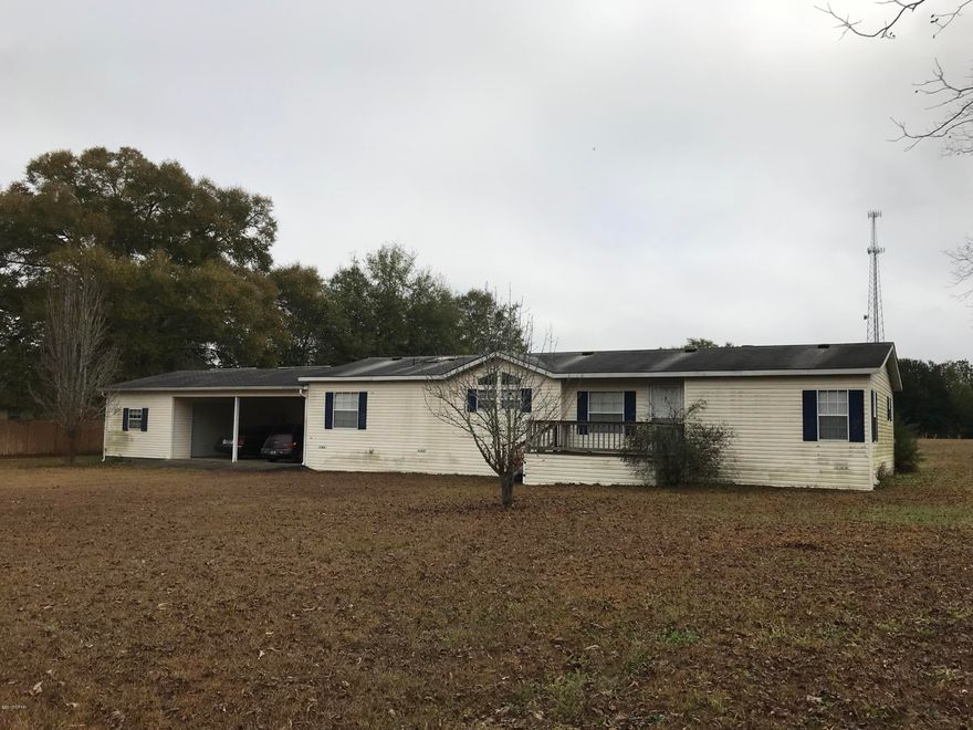 ARE YOU LOOKING FOR A SPACIOUS HOME AT A LOWER PRICE.  If you know how to put your own roof on or can get it done reasonably, then this is the property for you.  Mobile home roof sustained some Hurricane damage & will need to be replaced .  Seller is wanting to sell ''As Is''' for Cash & not have to incur the expense & time of replacing it himself.  3BR/2 bath custom built mobile home located on approx. 1.2 acres just outside of Greenwood, Fl.  Paved road, attached carport & workshop/storage w/roll-up door & huge 32 x 36 metal barn w/ roll-up door. Back  porch to enjoy your coffee & watch the wildlife. All rooms are very spacious with plenty of storage & cabinet space.  Make an appt. to view today