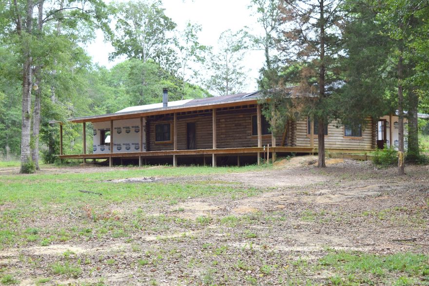 LOOKING FOR A PROJECT? This log cabin has been gutted to the studs and is awaiting your personal touches. Prior owner has added approximately 800 sq foot of living space, attached garage and also started some plumbing work. House needs extensive renovations but has great potential. Outside features include partial wrap around porch, pond and well/septic. Home is being sold As-Is, all measurements are approximate and should be verified by buyers.