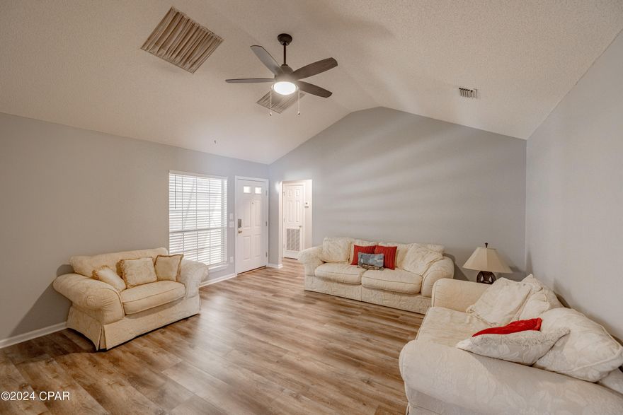 CURRENTLY UNDER CONTRACT, SELLER WILL CONSIDER BACKUP OFFERS' This Inviting 3-bed, 2-bath home is within walking distance to the beach, boasting 1,300+ sqft. This home Features a durable metal roof, 2-car garage, storm shutters, storage building, and a charming covered patio all without an HOA. Enjoy your privacy in this large backyard with a privacy fence, and most importantly NO HOA!! Inside, you'll find a modern kitchen that flows into the dining area with quartz countertops, updated cabinetry, stainless steel appliances, and stylish tile backsplash. The great room offers ample space, while the master bedroom dazzles with a private updated bathroom with updates such as a double vanity, quartz countertops, and updated cabinets. Additional bedrooms provide plenty of space for family and guests. Along with the updated additional bathroom to accommodate them.  Other highlights include updated garage floors, and a spacious backyard. This home is the epitome of coastal living and is a must see!