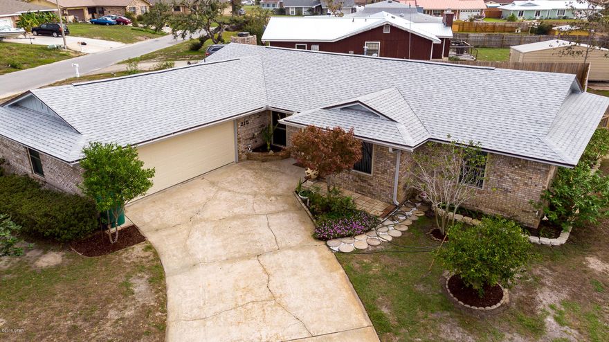 Incredible home close to Tyndall A.F.B. and with an additional lot.  This  brick home has been fully remodeled with a new interior look, including a new roof, new kitchen with stainless steel appliances, granite island with breakfast bar, new cabinets...and open floor plan overlooking the large living room with fireplace.  As you walk into the foyer, you are greeted with a  large formal living room on the right and formal dinning room on the left.   New flooring throughout to include new carpet, wood and tile. All new interior painting and large laundry room.   Large family room overlooking the ample yard through glass doors throughout.  Master bedroom with walk in closets and newly remodeled master shower and hallway bathrooms.  The garage has two entrance and back yard fully  fenced. This home has an additional lot on the right side, which could possibly be divided etc and adds addtional value to the property.  Home sits on a corner lot.  The home is well maintained and manicured.   Come see this home and make an offer.