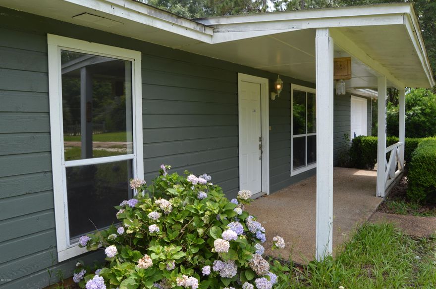 BEAUTIFUL HOME IN A QUIET COUNTRY SETTING ON 1 ACRE; Completely Renovated, this home is almost brand new on the inside.  Fresh Paint, New Carpet, upgraded Bath Room, New Kitchen Counters and nobody has lived in home since renovated.  This spacious home with 3 bedrooms, 2 baths originally built in 1985 looks like 2016 inside. As you enter the home you are greeted by a large open Great Room and a warm inviting Fireplace. The fully equipped kitchen includes all the appliances and it has all new Countertops. This home is spotless and is turn-key Move-In-Ready.   The exterior offers a large yard with an Open Air Patio perfect for Grilling and relaxing. This Like New Home comes complete with new AC unit (inside and out) and is ready for a New Owner.  Make an appointment to see it today. This great home is located about 20 minutes from the Panama City Mall, restaurants and schools.  Additionally, this home has an additional Detached Garage and once had two Horse Stables.  Bring the Horses, Dogs, Cats and Friends and Family!  This home has room for them all.  All information and measurements are approximate, buyer to verify all deemed important.   With space to grow your own Food, New Energy Efficient Double Pane Windows combined with Money saving Deep Well water and Septic make this home much more affordable than you may think.