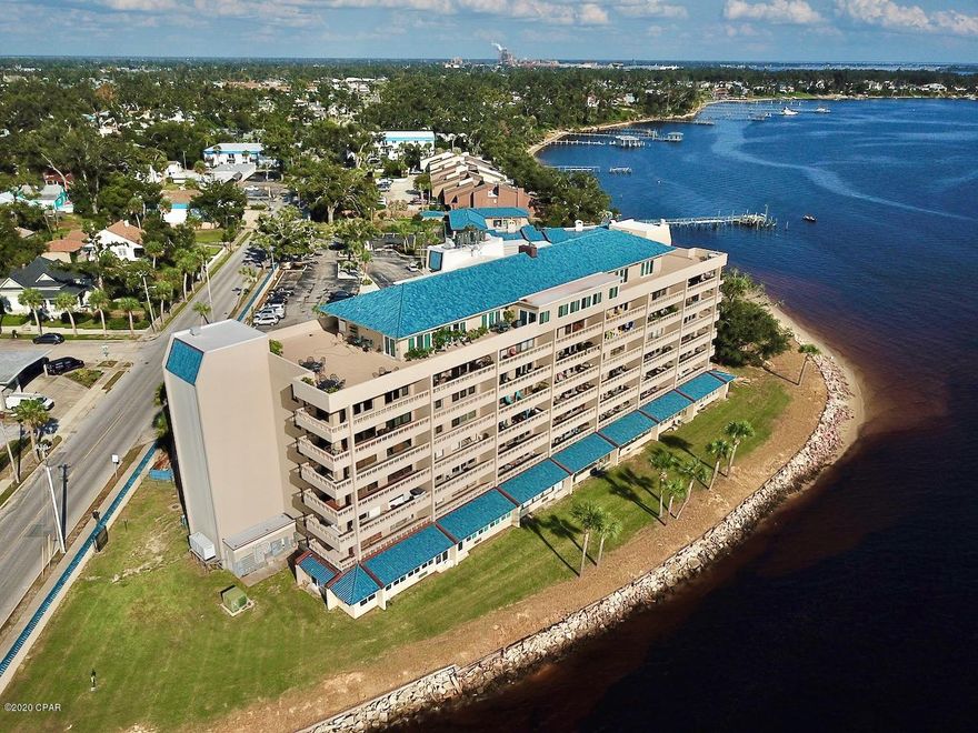 Cove Condo has recently renovated from storm damage. NEW roof, hardieboard siding, railings, paint, windows, doors and porthole skylights, new support piling on water side. Only 57 unit project with pool & dock. Beautiful view of Grand Lagoon from private balcony on 5th floor. Close proximity to St Andrew State Park, public beaches, golfing, marinas, boat slips and storage, pontoon boat and jet ski rentals, charters & tourist attractions & fine dining. Ready for its new owner to make their own, new Hurricane Sliding Glass doors installed before the storm and was one of the only units that did not have interior damage. Owners may have pets. Prime waterfront location. Reasonable HOA fees.