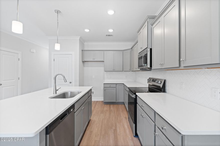 NO RENTAL RESTRICTIONS!!! Our stunning pool is NOW OPEN! The prefect place to SOAK UP THAT Florida SUN! Seagate at Clara is a new townhome community nestled in the vibrant city of Panama City Beach, FL. This two-story unit features board and batten exterior and covered entries. One car garage provides a great space for storing beach essentials. This Unit has a LARGE FENCED IN PRIVATE YARD.  This open concept townhome boasts a stylish kitchen with white cabinets, tile backsplash, a large island with quartz counter tops - perfect for entertaining.  The elegant Owners Suite is designed with comfort in mind showcasing a large walk in closet and double- bowl vanities. Main Bath has tiled shower.  All bathrooms have quartz countertops.  LVP is located throughout the home.  The community pool features a cabana, lounging, seating and grilling stations. This community has a dedicated dog park. Seagate at Clara is in a prime location, approximately 1.4 miles to the sandy beaches and just minutes from Pier Park.