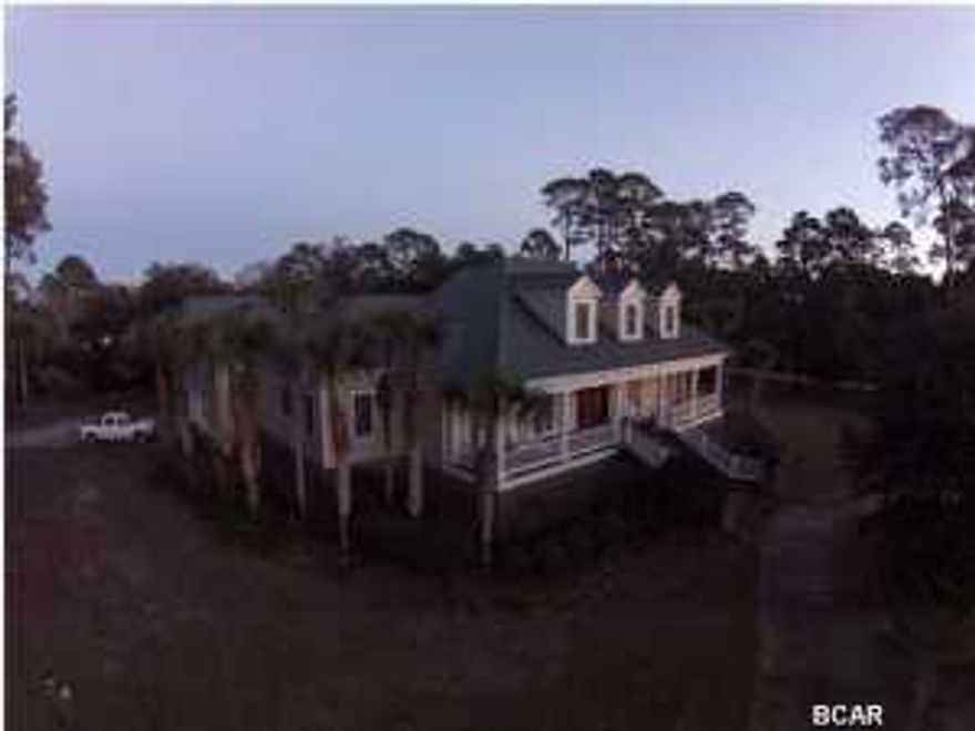This Elegant custom built estate overlooking St. Joe Bay is one of, if not, the nicest homes in Port St. Joe. The home features over 7500 total sq ft and sits on over 1.7 acres with 265 feet fronting St. Joe Bay. The attention to detail on this home is extremely impressive with abundant millwork throughout, a beautiful floating spiral staircase, marble floors, executive chef's kitchen w/ Viking appliances, separate mother-in-law suite, incredible master bedroom and master bath, private pool, 3 car garage, wonderful porches, and way too many extras to list. Purchased for $1,900,000 and being sacrificed at an incredible value.