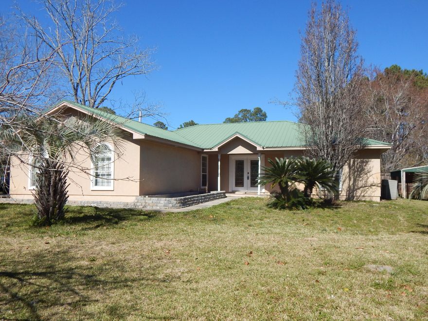 This house is a great opportunity--large corner lot with water view - House has open floor plan; stainless appliances;  wood burning fireplace; large screened in porch; oversized garage; Storage building in the back yard; metal roof. Call for an appointment to view this waterview house on a huge corner lot. All measurements  are approximate & should be measured if important.