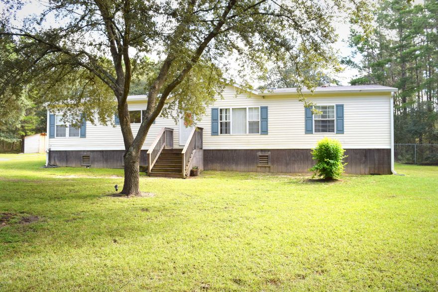 Country living at its best! Drive up the gravel driveway on you way home to this 3 bedroom, 2 bathroom mobile home, surrounded by a canopy of large trees, on a 3.33 acre, gorgeous, wooded lot! This home has an open, split floor plan, large chef's eat-in kitchen with island, built in work desk, laundry room with an excess of storage, The oversized owner's suite features a walk in closet, soaking tub, separate shower, double sink vanity and a make-up vanity, both additional bedrooms are complete with a walk-in closet and spare bath is equipped with double sinks as well.  Property is located just off Hwy 77 close to Bozeman and a short drive to Panama City and the beaches.