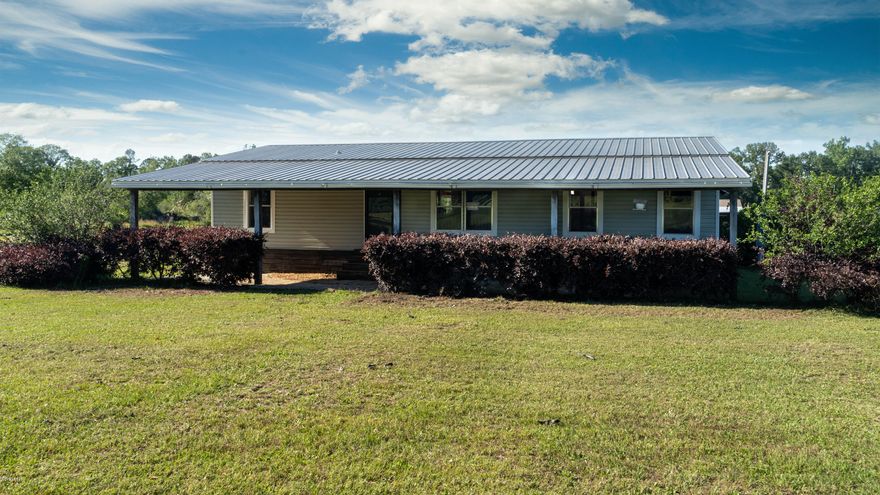 11 Acre Mini Farm with a modern Open Floor Plan 2008 Mobile Home.  The Living Room is the center of this well maintained home that features a split floor plan with Large Master Bedroom suite and two guest bedrooms on the opposite side with private bath.  Located minutes from downtown Bonifay, You might just fall in love when you arrive and see the potential this property has for most anyone.   You can plant your own personal farm, raise chickens, and have horses.   Don't decide on this property until you have the chance to sit on the front or back  covered porches.  They are great for relaxing and watching the sunrise and sunset.  All info and measurements are approx., buyer to verify all deemed important.  Come see this beautiful property today and make an offer before someone else does Park your vehicles, toys, boats in the 24 x 36 Carport/Pole barn with concrete floors and begin all those projects in the workshop that is wired with electricity.  There are very few limits to the potential this property offers with lots of room for pool, pets, friends, family and so much more.  
This land consists of the Main Home, carport/pole barn, Well, Septic, Pump house, Workshop.  The home consist of two extra-large covered porches front and back and has newer appliances (2017) and washer dryer that all convey with approved purchase offer.   Don't miss this one, it is worth the time to visit.   NOTE:  Chicken Coop doesn't Convey with Purchase but may possibly be purchased separately if desired.