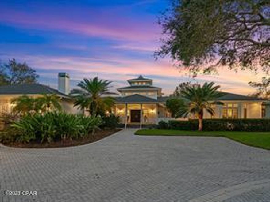 If you are looking for a grand Florida estate on deep protected water, you've arrived at your destination! Grand yet not ostentatious, secluded and secure, this beautiful property is reminiscent of the southern homes of yesteryear, yet updated and responsive to today's high-tech needs. It is a waterside oasis nestled on 5 acres of mature trees and pasture, close to everything yet away from it all. These estate properties are usually found out east, however, 411 Lychee Road is west of the Trail right on deep protected sailboat water. The entry gates take you down a sweeping oak canopy driveway beside Florida pasture to a second set of gates and up to the main house.