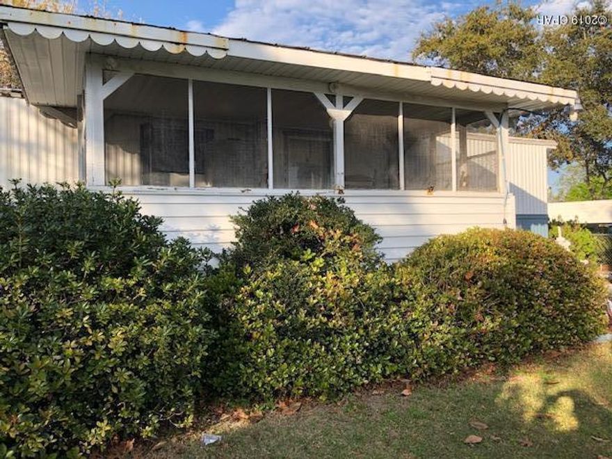 Popular Laguna Beach location for this price? This charming lot and mobile home are on the south side of Back Beach Rd and great for a vacation home or investment property.

Lots of love has gone into making this place a memorable vacation spot for a family for years with lots of storage for their ''toys''. The kitchen has a pantry and loads of cabinets for storage. Open living and dining area and has nice carpet. The master suite is surprisingly spacious and has his and her closets. Great front porch to sip cool iced tea, & visit with friends and family. Back porch has an extra refrigerator which is so handy at the beach.  The yard has a irrigation system in place & the home has been coated with Elastomeric paint top to bottom. All Information is deemed to be reliable, but is not guarante