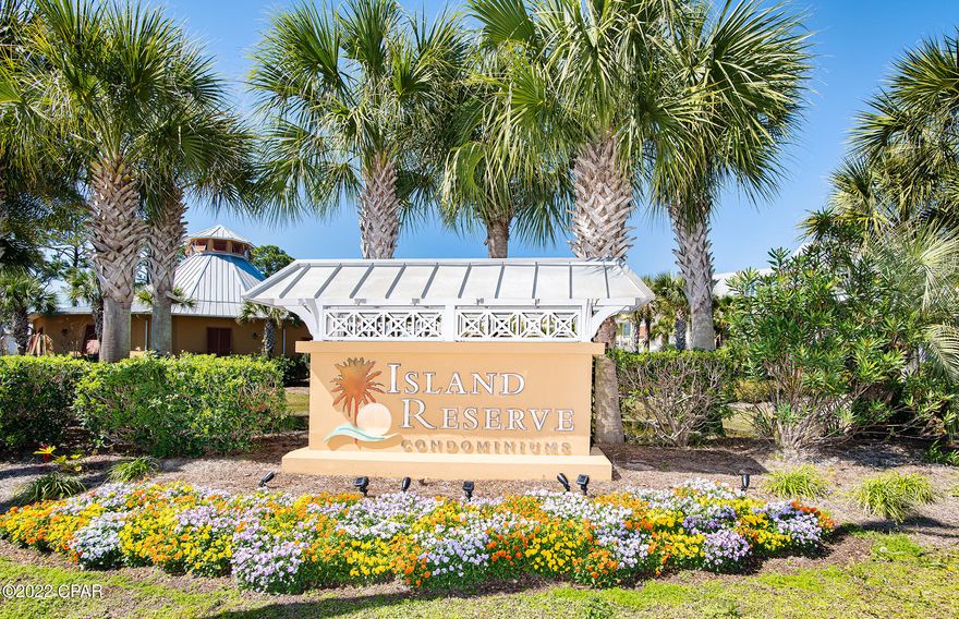 Welcome to the island!  Island Reserve is a gated community with NO SHORT TERM RENTALS.  Located just minutes to the beautiful white sandy beaches, this well kept secret has a laid back lifestyle and endless amenities.  Enjoy the zero-entry acre island pool, hot tub, state-of-the-art fitness center, movie theater room, indoor pickle ball court/basketball court and a nice community room including a pool table. Fantastic location convenient to restaurants and shopping!  Drive right up to the second floor parking garage and you will be steps away from your condo.  Upon entering the unique foyer area, you will love how it opens into the living/dining area and kitchen.  Great for entertaining.  The kitchen offers an island bar, granite countertops, undercounter lighting, newer stainless steel appliances, and newer upgraded light fixtures.  This gem has crown molding in the living room, 10 foot ceilings, ample storage, and newer 4-inch custom plantation shutters throughout.   Beautiful Luxury Vinyl Plank flooring in living/dining areas, bedrooms, and closets.  Tile in baths, kitchen and foyer.  The washer and dryer is also included with the condo.  New water heater.  Enjoy two master suites that boast their own private access to the relaxing balcony.  Each bedroom also has walk-in closets.  One of the bathrooms has a large bathtub and separate shower while the other bathroom just has a shower and lot's of storage space.  There is also a half bath off the foyer for guests.  At Island Reserve you can get outside and walk through the courtyards while enjoying various fountains and beautiful lush landscaping throughout the property.  Come to ''the island''!  Don't miss your slice of paradise.