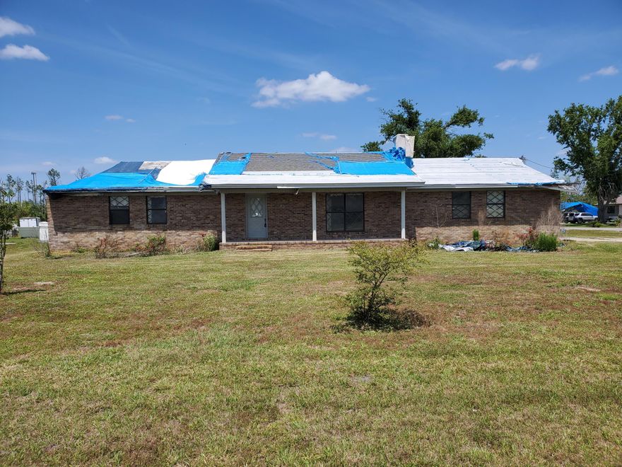 All brick 3/2 with office. Home was damaged during the storm and is in need of renovation. Home has huge brick fireplace, oversized two car garage. A 24x20 detached 2 car workshop with power. Lot is over half an acre. A great location. Home is on well and septic.