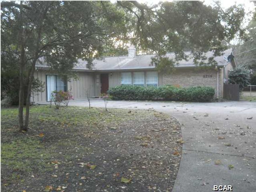 Split bedroom home located in convenient location between Lynn Haven and Forest Park. This 3 bedroom 2 bath home sits on a large wooded lot, approximately 1/2 acre, features ceramic tile and carpet, fireplace in the living room and large den. This is a Fannie Mae HomePath property. All information is taken from public records. If important to buyer, please verify.