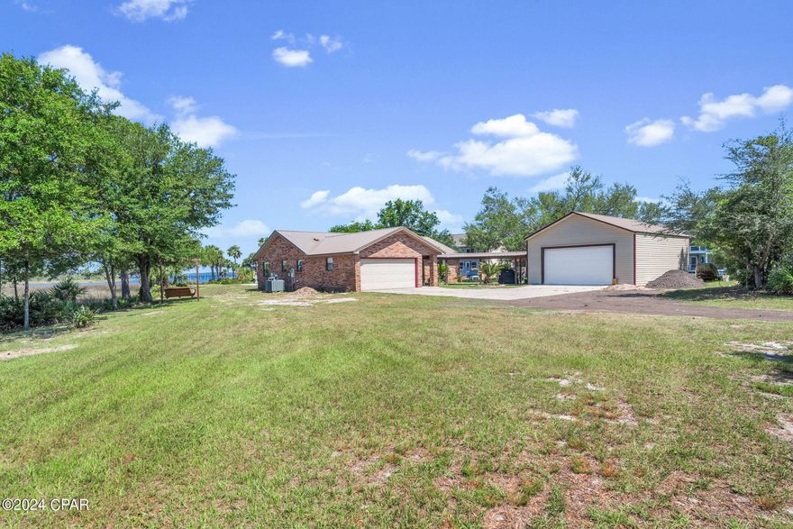 CURRENTLY UNDER CONTRACT. SELLER WILL CONSIDER BACKUP OFFERS. Beautiful WATERFRONT OASIS awaits you! This stunning property is nestled on 1.6 acres of land , surrounded by Bay, Canal and Bayou. Absolutely amazing sunsets! Home also features an in-ground gunite pool! The home is  all brick with vinyl trim. Inside you are welcomed by a huge greatroom with vaulted ceilings and a glassed in Florida room for unobstucted views of the water. The spacious kitchen has been redone with granite countertops and custom cabinets. There are 3 large bedrooms and 2 baths (with a jacuzzi tub in the 2nd bath). Home also features a 2 car garage and a 24 x 30 garage attached by a covered walkway. There a 10 ft walls in the detached garage and an 8 ft door for ease in getting the boat inside! Easy access to canal for kayaking and water activities. Upgrades in 2016 include: custom trim,porclein tile throughout house, bedrooms have upgraded nylon carpet, custom tile shower and all cabinets were replaced . 120 ft of vinyl seawall in the canal. Upgraded lighting throughout including programmable soffit lights. Don't miss this opportunity to own a estate size waterfront property close to town. Make an appt to see it before it's gone!