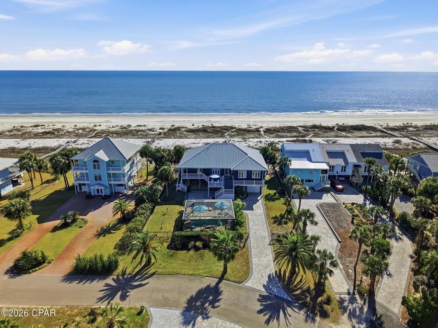 Rare Gulf Front Home-Old Florida Privacy. Welcome to 170 Gulf Pines Dr in Port St. Joe, FL, an exceptional coastal home offering relaxed Gulf living just steps from the sugar-white sands of the Gulf of America. This beautifully maintained residence features 5 bedrooms, 4 full bathrooms, and 2 half bath across 2,677 square feet of living space, making it ideal as a primary residence, second home, or vacation rental investment. The home's striking coastal exterior, durable metal roof, and elevated design are showcased in the photos and drone footage. Expansive covered porches provide inviting spaces to enjoy Gulf breezes, morning coffee, and evening sunsets, with peaceful views of the surrounding neighborhood and glimpses of the water. Inside, the spacious layout is designed for comfort and functionality, offering ample room for family and guests. The elevated construction enhances natural light and airflow, while the generous bedroom and bathroom configuration provides privacy and flexibility for entertaining. A large custom ''Container Store'' pantry gives one more ease of daily needs. The exceptional front-yard outdoor living area, thoughtfully designed into a private, resort-style oasis. The screened-in pool enclosure creates an open, airy atmosphere while providing shade and comfort, allowing the pool to be enjoyed year-round. Surrounding deck space offers plenty of room for lounging or entertaining. Beneath the home, a ground-level screened-in living/entertainment area provides a shaded, breezy retreat ideal for outdoor dining, relaxing, or gathering with friends and family after a day at the beach. Easy access to the pool and front yard enhances the home's seamless indoor-outdoor flow. Add'l features include a garage, ground-level storage for beach gear and water toys, and generous paved parking. Located in the desirable Gulf Pines community, this home offers easy access to downtown Port St. Joe, dining, shopping, boating, and miles of pristine Gulf beaches.
