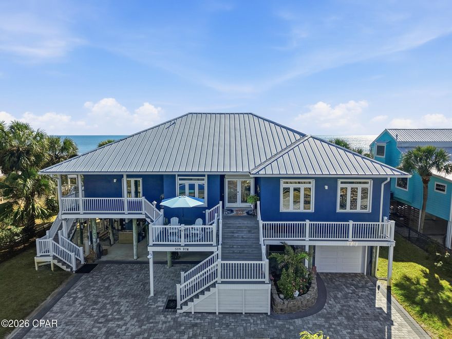 Welcome to 170 Gulf Pines Drive in Port St. Joe, Florida—an exceptional coastal home offering relaxed Gulf living just steps from the sugar-white sands of the Gulf of America. This beautifully maintained residence features 5 bedrooms, 4 full bathrooms, and 2 half bath across 2,677 square feet of living space, making it ideal as a primary residence, second home, or vacation rental investment. The home's striking coastal exterior, durable metal roof, and elevated design are showcased in the photos and drone footage. Expansive covered porches provide inviting spaces to enjoy Gulf breezes, morning coffee, and evening sunsets, with peaceful views of the surrounding neighborhood and glimpses of the water. Inside, the spacious layout is designed for comfort and functionality, offering ample room for family and guests. The elevated construction enhances natural light and airflow, while the generous bedroom and bathroom configuration provides privacy and flexibility for entertaining. A large custom ''Container Store'' pantry gives one more ease of daily needs. The exceptional front-yard outdoor living area, thoughtfully designed into a private, resort-style oasis. The screened-in pool enclosure creates an open, airy atmosphere while providing shade and comfort, allowing the pool to be enjoyed year-round. Surrounding deck space offers plenty of room for lounging or entertaining. Beneath the home, a ground-level screened-in living and entertainment area provides a shaded, breezy retreat ideal for outdoor dining, relaxing, or gathering with friends and family after a day at the beach. With easy access to the pool and front yard, this space enhances the home's seamless indoor-outdoor flow. Additional features include a garage, ground-level storage for beach gear and water toys, and generous paved parking. Located in the desirable Gulf Pines community, this home offers easy access to downtown Port St. Joe, dining, shopping, boating, and miles of pristine Gulf beaches.