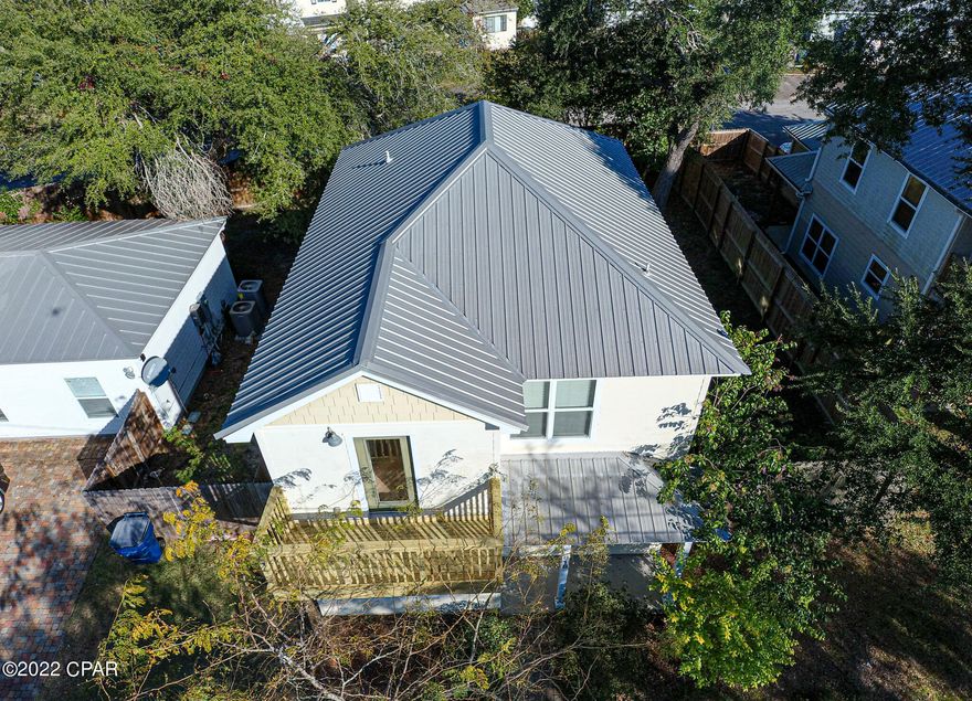 Beautiful move-in ready home close to St. Andrews and downtown Panama City.  Blocks away from the Panama City Garden Club and walking parks for both you and your pets. Outside first floor has been complete updated with new plywood, Hardie board siding, and painted.  The interior was repainted with neutral colors that will match any Décor. As you enter the front door you are greeted with a large open great room and kitchen with real wood floors. Fantastic for entertaining and get togethers. Enjoy cool mornings and evenings in you cover back porch, also great for setting up your BBQ. Master bedroom has a walk out balcony that was just completed replaced. Double sink vanity in the master bathroom with tile walls around shower and tub.  Large double door closet and carpeted floors finish out the master bedroom. Spare bedrooms are a great size with large closets. Upstairs hall has 2 large double door closets for linens and storage. Front covered porch is a great place to sit and enjoy cool evenings. Large oversized garage, with opener, is located on back of home and is entered from Premier Drive. Garage is equipped with a commercial grade wall a/c unit for climate control. Energy efficient A/C heat pump and Rinnai on demand tankless water heater help keep utility bills lower. All measurements are approximate, please verify if important. Contact your favorite Realtor for a showing today.
