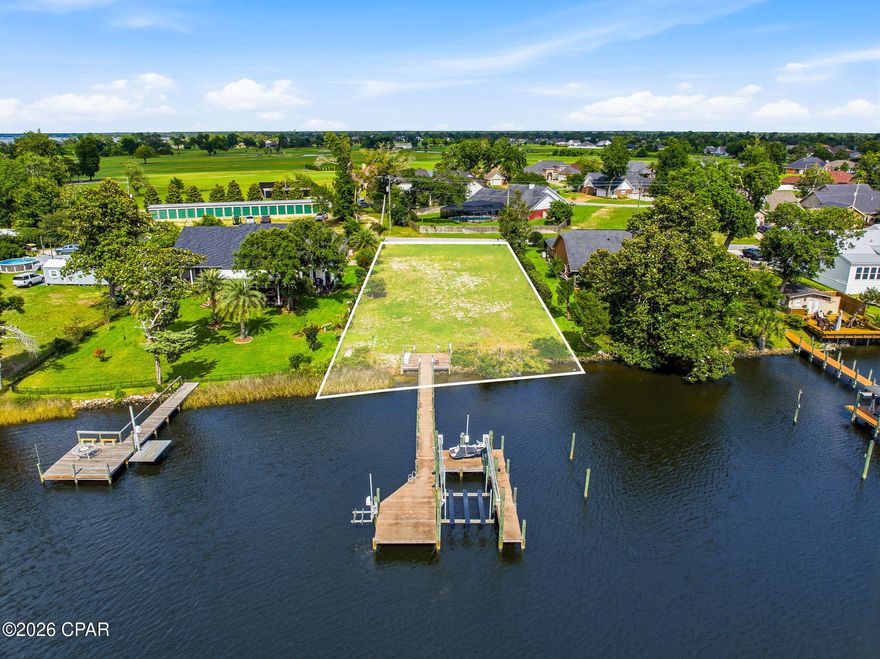 Build your dream waterfront escape on this rare vacant lot featuring a stunning, like-new dock already in place. Thoughtfully designed for both relaxation and adventure, the dock includes two boat slips and two wave runner lifts--perfect for making the most of life on the water from day one.

With water and sewer already connected, much of the groundwork is done, saving you time and expense as you bring your vision to life. Enjoy the freedom of no HOA, giving you flexibility to create the coastal retreat you've always wanted.

Ideally located just steps from Panama Country Club, you'll have convenient access to golf, dining, and social amenities while still enjoying the privacy and tranquility of your own waterfront haven.

Opportunities like this are rare--premium lot, unbeatable location, and ready-to-enjoy waterfront features all in one.