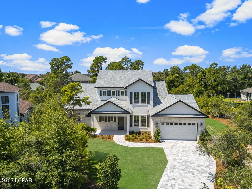 Stunning brand new home on an oversized lot in the beautiful, upscale, gated community of Preserve on the Bay, in the heart of Panama City Beach. This one of a kind home features 3,084 sq. ft. of luxury living with an inviting open floor plan, which comprises 4 bedrooms and 3 1/2 baths. As you enter the home you are immediately greeted with quality and class, an expansive open plan design, beautiful hardwood floors, a large living area with extensive use of windows overlooking the professionally landscaped back yard and natural preserve area.

The large formal dining room, separate Breakfast Nook, wood flooring throughout the main areas and Master Bedroom, extensive use of trim, granite counter tops, 10' ceilings, and 8' doors throughout are just some of the other exquisite features of this home. For the cooking enthusiast, the large open plan Kitchen features stainless steel appliances(which includes a natural gas cooktop, wall oven, french door refrigerator), an oversized walk-in pantry, a large island incorporating a breakfast bar, and plenty of windows overlooking the back garden allowing plenty of natural light to filter into the kitchen.  The home also comes equipped with a tankless natural gas water, irrigation system, and an ample amount of storage closets.

The Master Suite wing features an oversized bedroom, double walk-in closets, double vanity sink, a free standing soaking garden tub, and a beautiful separate tiled glass enclosed shower. This is a highly energy efficient and well constructed home utilizing 2''x6'' framing which allows for enhanced insulation values, as well as double paned low-E windows. The home is backed by the peace of mind of a Sellers Warranty. All dimensions are approximate, please measure and verify for accuracy.