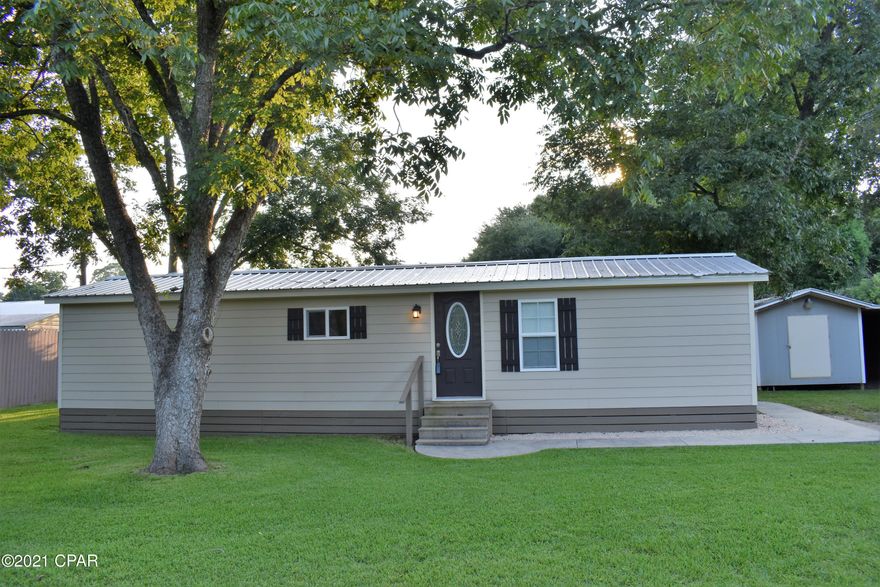 CURRENTLY UNDER CONTRACT, SELLER ACCEPTING BACKUP OFFERS - RENOVATED BEAUTY within walking distance of restaurants and the new Dollar General that is currently under construction.  You won't believe that this is a manufactured home!  It has had a complete overhaul and features many characteristics of a site built home.  Hardie board siding and a concrete entry-way nestled amongst beautiful pecan trees give this home outstanding curb appeal. 

Among the extras are fenced privacy, a spacious cooled workshop with plenty of storage inside and out to tinker with your tools and park your toys.  If that isn't enough, an extra outbuilding is available for storage.  A built on addition makes this original single-wide a spacious room for a night with the family.  Don't miss out on this beauty!