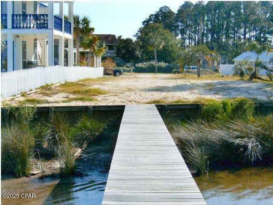 Build your lagoon front home here. A flat, cleared lot with incredible waterfront on Grand Lagoon with a seawall and 180' dock. Perfect for your residence or vacation home. Only minutes to Shell Island and close to great restaurants. Perfect water for a Pontoon Boat. Seller is a licensed real estate agent in the state of Florida.