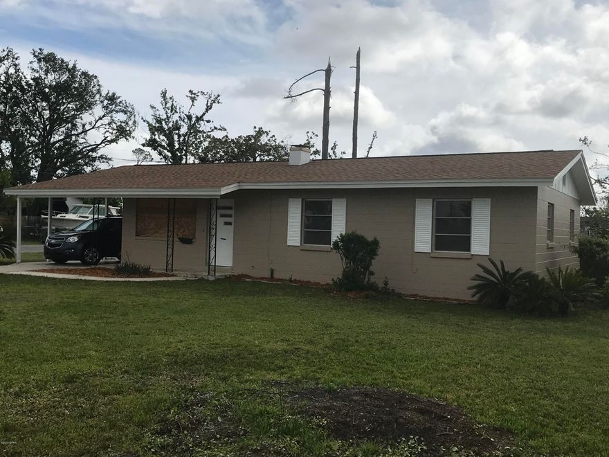 SOLID well-built block home on a 1/4 acre corner lot.  Sellers have completed all hurricane damage repairs with the exception of all new doors and windows which will be installed in early May,  This house boasts a NEW roof, flooring, most inside doors, master bath toilet and sink, all new interior trim, refrigerator and new light fixtures as well as a new cover over the outdoor patio.  It has also been freshly painted inside and out. This house is move-in ready and is priced to sell quickly.