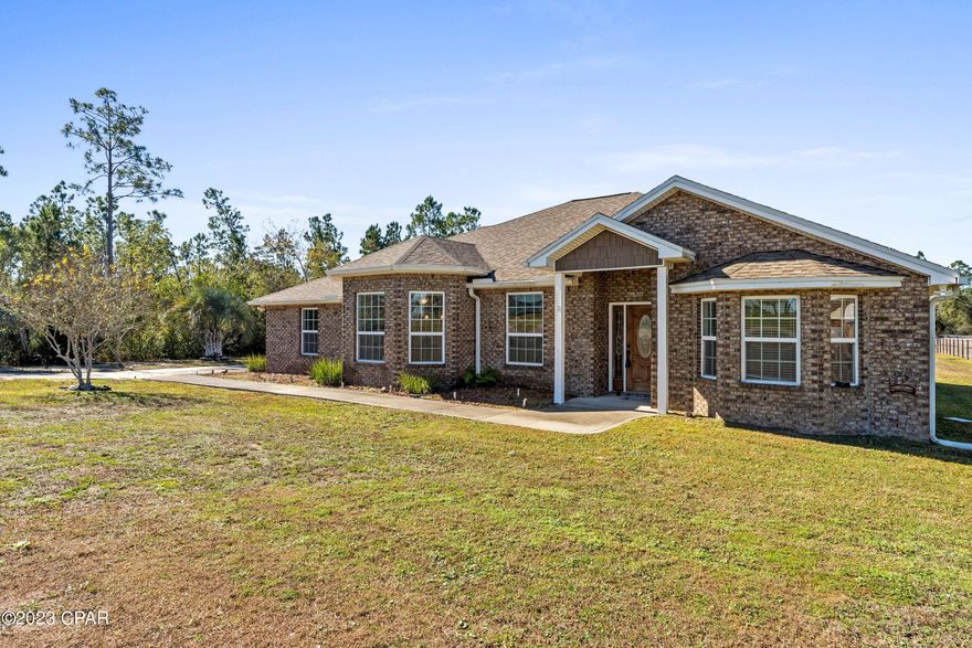 Rare find! This home features exterior brick on all sides as well as a beautiful and spacious split floor plan. Brand new Ryobi riding lawn mower comes with the house! High-end 24x24'' ceramic tile throughout, tray ceilings in master and living room along with tall ceilings throughout make this home feel open and grand. Home comes completely furnished and equipped including stainless steal appliances, high-end washer/dryer and a Ryobi riding lawn mower. Move-in ready or market it as part of your rental portfolio! No HOA means you can use your property as a primary, secondary or investment home!  This home features granite counter tops in the spacious bathrooms and kitchen. The garage and parking is very efficient, plenty of space for cars and toys. Driveway can easily fit boat trailers, RVs and more. The back patio features pergola, stone pavers, a built in swing and fire pit. With very few street lights in the area, the stars at night are magnificent. The north end of the property is lined with beautiful fencing and the south and west end of the properties are surrounded by a dense tree line. Directly across the street is Old Majette Park (frisbee disc course, walking trail, stocked fishing pond & more). Only 10 minutes to the nearest grocery store, 15 minutes to the heart of Panama City, 20 minutes to Tyndall Air Force Base and 35 minutes to the white sandy coast line of Panama City Beach.

Additional features of the home include irrigation, back-lit palm trees, exterior electric, septic tank, city water and coop electric. The HVAC system is new within the last 2 years.