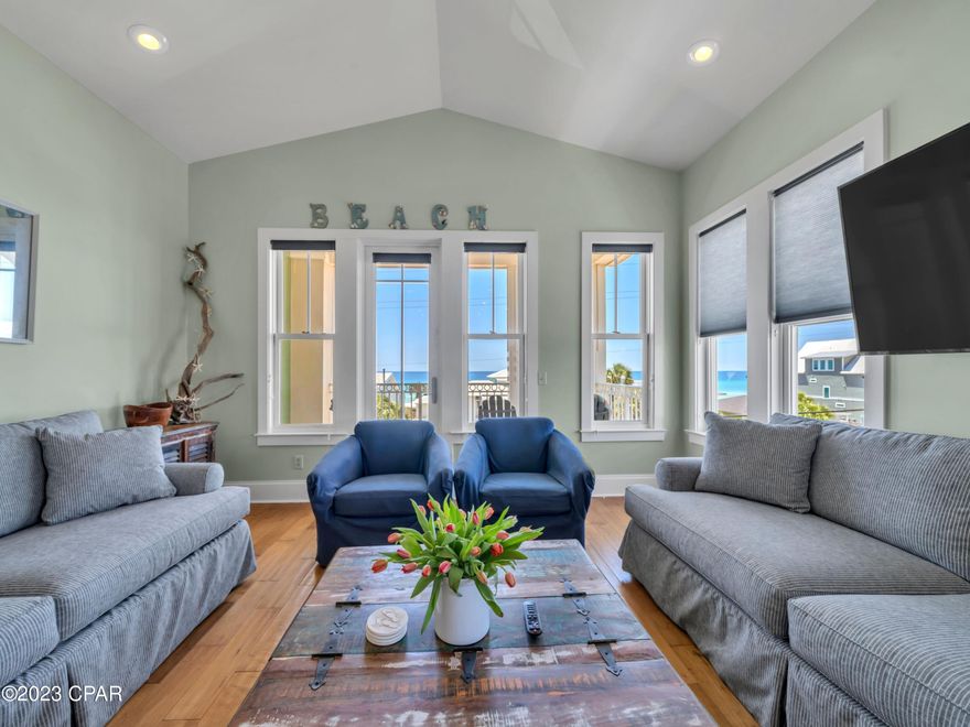 Located between Pier Park and Thomas Donut and Snack Shop, just 100 yards from the beach, this stunning beach house is all about location. Spread over three levels it has a lock-out suite on the ground floor and stunning gulf views from the gorgeous third-floor living space. The hydraulic elevator makes every floor easily accessible. Totally remodeled in 2022, this home is large enough to be a main residence, but could easily accommodate 14 guests as a vacation home. Sold furnished, it has high-impact windows, a new metal roof, fresh paintwork, granite counters and hardwood flooring making it rental-ready. With no HOA fees, it is highly attractive for investors. The first-floor lock-out is self-contained with its own kitchen, king-size bedroom, spa bathroom and living room with sleeper sofa. Two king suites with private balconies plus a bunk hall take up the second floor while the third floor boasts expansive open living space with breathtaking gulf views from the balcony. There's also a luxurious master suite with built-in closets, a whirlpool tub and a private balcony on this floor. Gleaming hardwood floors and a cathedral ceiling create a bright and welcoming living space. Two comfy sleeper sofas in the sitting area increase sleeping capacity. There's a fully equipped coastal antique-style kitchen with granite countertops and stainless appliances for keeping everyone fed and clean-up is easy with a central vacuum. The dining table is supplemented by a wraparound breakfast bar with stools. The home has outstanding gulf views from the third-floor balcony, which is sure to be the hub for sunset drinks and evening get-togethers before dinner. Set behind a privacy wall, the heated pool and spa will keep everyone cool and entertained each day when not enjoying swimming and watersports at the beautiful beach. Light up the barbecue for poolside parties on the paved patio. With parking for six vehicles plus garage storage for beach toys and bicycles, this is the perfect vacation home.