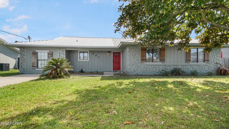 ATTRACTIVE LYNN HAVEN HOME IN A SIDEWALK COMMUNITY! The interior features 4 bedrooms (OR 3 bedrooms with a bonus Living Room), 2 baths, an open floor plan (good for entertaining), a wood burning fireplace, an XL interior laundry room, carpet in the bedrooms, and ample natural light. The kitchen boasts granite counter tops, an island with breakfast bar, stainless steel appliances, stylish lighting, and a pantry. The master bedroom can accommodate king size furniture and has an adjoining bath with tiled shower. The exterior features a fenced backyard, a back patio for grilling, a metal roof and solar panels. Ask your agent for more details! This home is a short drive to restaurants, schools, shopping, and more. NO HOA. X Flood Zone.  Call today for a private preview.