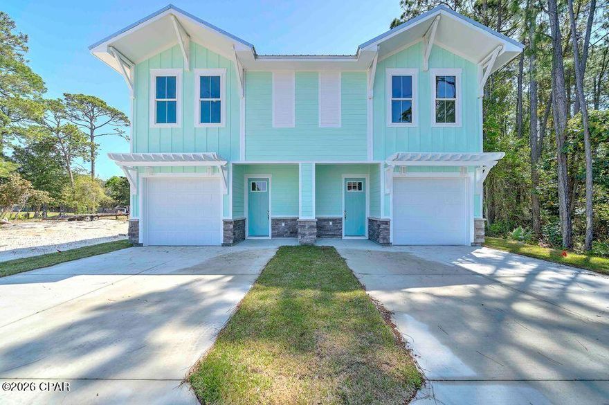 Located in the Upper Grand Lagoon area, this brand-new duplex has everything, and there's no HOA.  Priced below current appraisal, the construction engineering on this unit is remarkable. Some of the many features include the ''Quick Tie'' hurricane tie down system, spray foam insulation (for keeping low power bills), extra wide stairs, and 10' ceilings downstairs / 9' ceilings upstairs. Very open concept with quartz countertops in the kitchen and baths and LVP flooring. Each bedroom is an ensuite, and there's an additional half bath downstairs.  Outside, you will find Hardi Board and stone siding, a metal roof, privacy fenced back yard, and fully sodded yard with a sprinkler system. Close to beach accesses, this unit has a separate 10'x20' golf cart garage in the back yard with a roll up door and 220 power already stubbed out for a future pool or EV if desired. The very low maintenance construction is well thought out and basically worry free. Unit B next door is also available, allowing you to double your doors and income (ask about the discount). STR are allowed, and there is nothing left to do except decorate.  Measurements are approx.