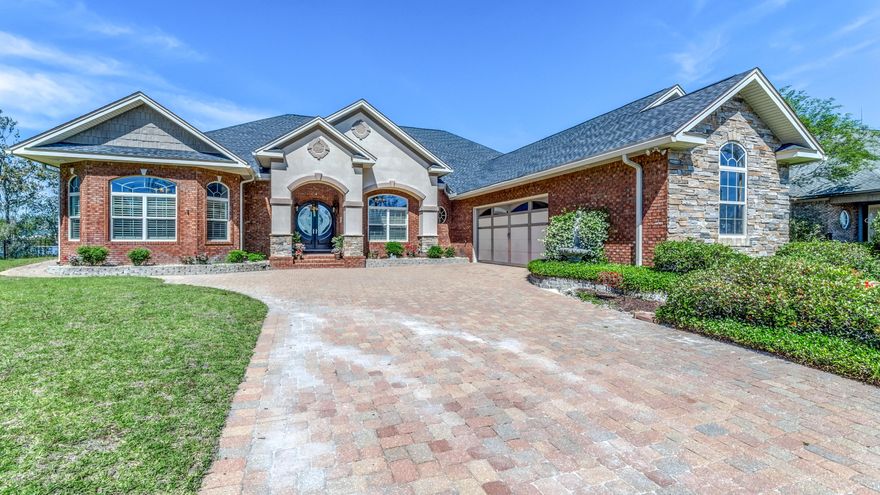 CURRENTLY UNDER CONTRACT, SELLER ACCEPTING BACKUP OFFERS This stately home was built by Allen Guthrie as their own personal home and now you have the chance to purchase their home.  Enter Bayou Oaks subdivision on Deerpoint Lake and the home is located at the end of the cul-de-sac with an unobstructed view of the lake. With over 3600 square feet of living space and over half an acre, there is room for everyone and everything.  As you enter the home, you will immediately notice all the custom features. The spacious dining room is immediately ahead of you with plaster walls, marbled columns and a leather faux painted ceiling. To your right is the cozy library with reading nook and bookshelves throughout. To the left is the large home office that could also be used as a bedroom. It has acloset, separate entrance and huge windows for lots of natural light. Beyond the office is the master suite. Features of the master bath include built-in hamper, dual raised vanities plus make-up vanity, water closet, whirlpool tub and huge walk-in shower. The master suite has a door to the pool area as well as two walk-in closets, one of which was thoughtfully constructed as a storm-safe closet with reinforced walls. Beyond the library your come to the kitchen of your dreams. Nothing has been overlooked - wine fridge, custom iron gate on the glassware shelves, large island with drawers, warming drawer, wall oven and microwave, pull-out shelves in the cabinets, cooktop with pot filler and beautiful tile back splash and another custom ceiling treatment.  The breakfast area even has a fireplace. All of this overlooks the spacious great room with fireplace and large built-in entertainment center. The two additional bedrooms share a jack-and-jill bathroom and one of the bedrooms has a Murphy bed with built-in lighting. There is also a half bath with access from the pool area. For your outdoor entertaining, the back yard can't be beat. The in-ground pool was just resurfaced, there is an outdoor kitchen with bar and grill and, of course, you are overlooking beautiful Deerpoint Lake for year-round water fun. There is even a chess/checker board in the yard. The utility room is big enough for an extra refrigerator and freezer as well as the ice machine. The oversized garage has space for a workbench, is wired for a generator and has a large storage closet. New roof, crown molding, built-in speakers, Shwinco windows and Anderson doors. the list of features goes on and on This is an expertly crafted and a much-loved home. Call your Realtor today for your personal appointment.