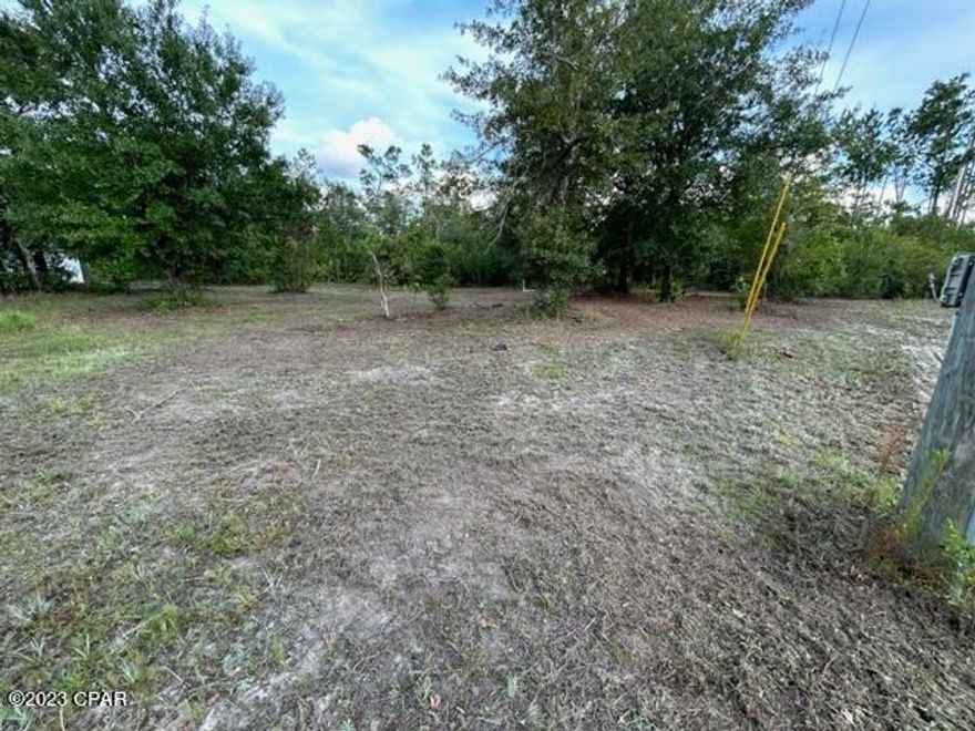 Large vacant lot located less that 450' off of a paved Rd. This lot is Zoned for mobile homes and is partially cleared already and has a 16x16 building on a slab already on site. No current utilities on this property.