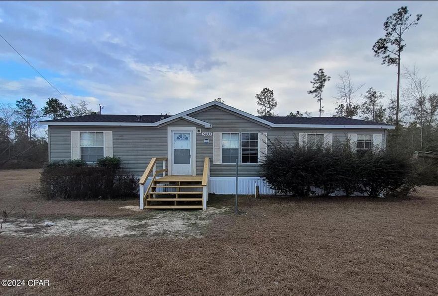 CURRENTLY UNDER CONTRACT, SELLER WILL CONSIDER BACKUP OFFERS. Nice country setting with this 3/2 dwmh on 1+/- acre in Greenwood. Home offers a spacious living room, eat in kitchen with plenty of storage and movable island. Split floorplan with master bedroom and master bath with garden tub, a separate shower, double vanity. On the opposite side of home is two additional bedrooms and full bath. Laundry room has access to back yard. Home has newer roof, flooring, and paint. Small outbuilding. Located on a paved road. Not far from Marianna for shopping, restaurants, or medical facilities.