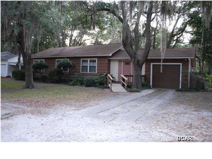 Three bedroom, 2 bath home in the heart of the Cove where beautiful oaks provide a peaceful backdrop to this well maintained home. Hard wood floors that the Cove homes are known for, easy to care for and obviously hold up well over time. There are many nice features that were thoughtful and make this a very livable home. The kitchen has been updated and features gas stove and newer cabinetry with corian cabinets. A kitchen island is on wheels to adjust to your needs with space for kitchen table and built in china cabinet. There are several box windows which bring the outdoors in with house plants or just enjoy the view. There is plenty of storage space as well. The master has five closets! There is a sliding glass door to enjoy the lovely back yard or step out and enjoy a cup of coffee