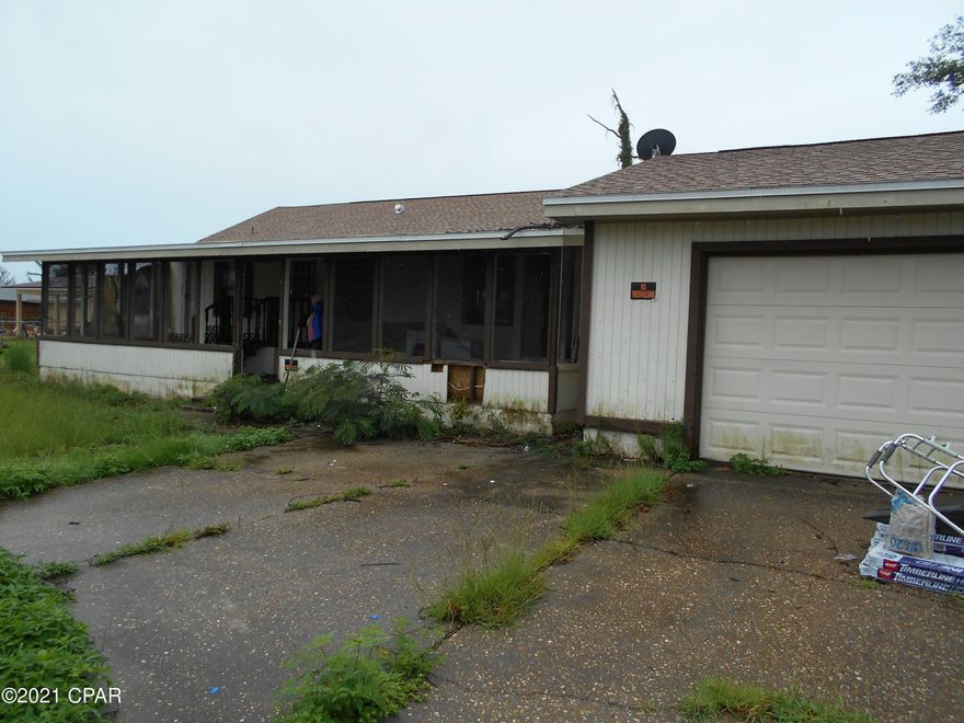 Back on market!  SELLER SAYS TO BRING ALL OFFERS!  This large home needs lots of TLC, but would make a great rental or first home when complete.  Home sits close to the north end of Transmitter Rd, and across the street from Grants Mill & The Landings subdivisions. Sellers installed a new roof recently, so it is dry inside, and ready for a make over.  Home has a wood burning fireplace in the very large family room, and a cooking grill built in to the back side of the fireplace on the porch.  Sitting on a full acre, the front yard has been cleared of hurricane debris, but the back half needs some attention.  Appears to be mostly fenced.  Large rooms, and a large solid 2 car garage, make this a real cubic zirconia in the rough.  Meas. are approx.