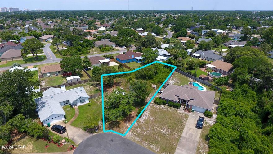 Rare find on a large buildable lot located at the end of a cul de sac in North Lagoon Oaks Subdivision. This prime location is just minutes from beach access, grocery stores, restaurants, Pier Park, golf courses, PCB Navy Base, and St Andrews State Park. Within 2 miles of boat launches and marinas making bay access easy. One of the last lots available in this subdivision totaling .34-acres waiting for your new beach house. No HOA and flood zone X. The seller has 3-bedroom/2-bathroom professional engineered house plans,1,932 sq ft with a 2-car garage available with full price offer. New survey done in 2020. Septic tank needed and city water available. Don't miss this chance to build your beach house in a perfect location!