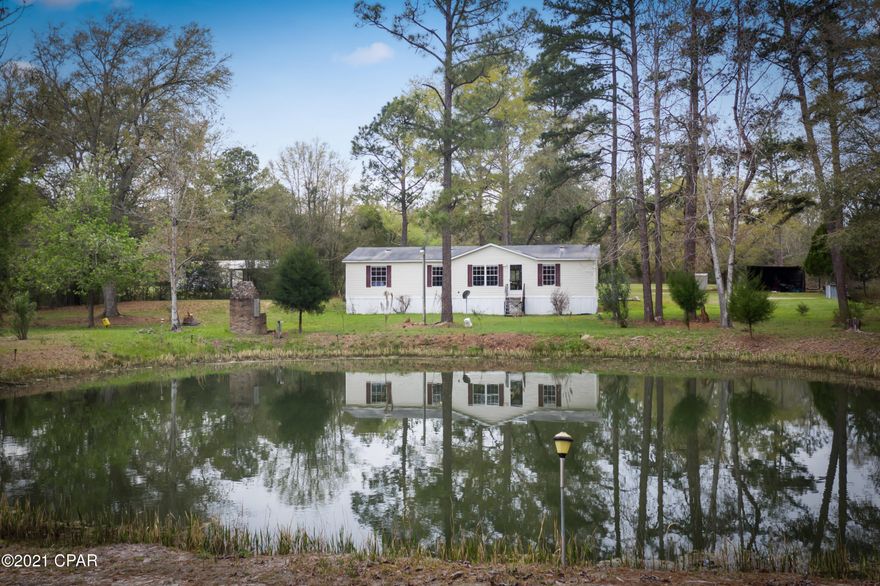 Nicely updated Mobile home on sitting on 2 acres overlooking Pond. Freshly painted with LVP flooring throughout. New cabinets in kitchen with stainless steel appliances with gas stove (propane tank is owned). Ac unit replaced in 2017. Large covered screened in porch across the back of home. Two detached storage buildings, pole barn has separate meter.