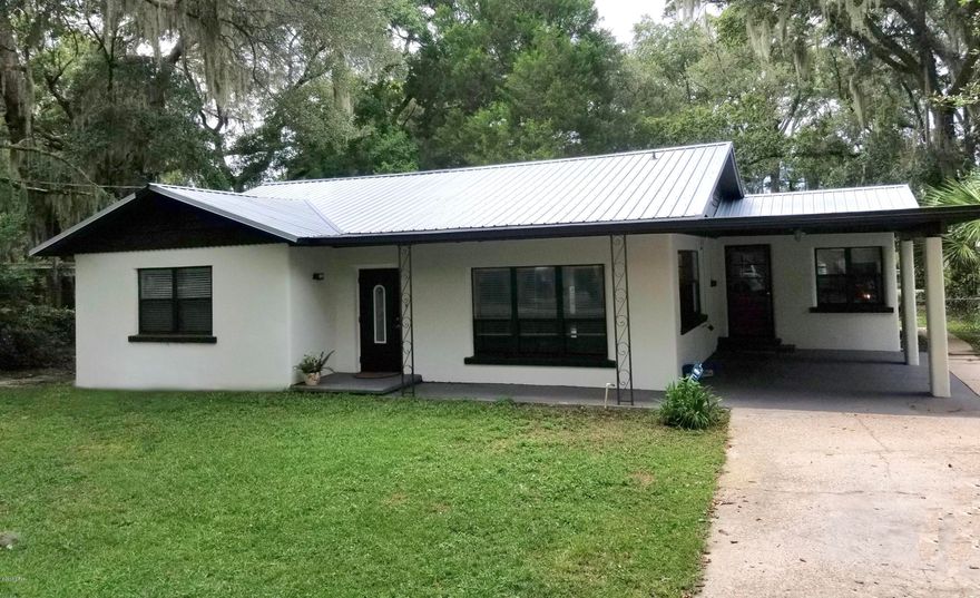 This lovely 3 bedroom, 2 bath home is renovated, the gorgeous original hardwood flooring refinished to preserve its original charm, while stainless steel appliances, sleek quartz countertops, subway tile accents, new  lighting fixtures, fresh paint and monitored security system offer modern convenience.  An abundance of windows dressed with  cordless blinds fill each room with natural light supplemented by additional layers of LED lighting throughout.  The oversized lot is tucked away on a quiet cul-de-sac only 3 miles from Tyndall Air Force Base and is home to fruit bearing orange, lemon and lime trees watered by a cost effective irrigation well.  The back yard is fenced in and can be accessed from adjoining Hickory St.  The back yard is fenced in and can be accessed from adjoining Hickory St, perfect for your boat!  Prime location is less than a mile from boat ramps, fishing, swimming, walking trails, a sports complex, an ecology park on the Great Florida Birding and Wildlife Trail and MORE!  Security alarm monitoring, as well as lawn care is provided for you at no charge, affording you more time to seize the day!!