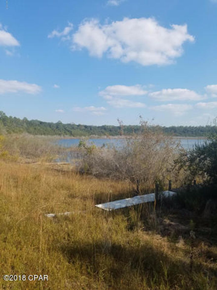 Vacant lake front lot, 1 acre with approximately 75 feet on the water.  Zoned for single family residence, this is a gated community with deed restrictions and 2 spring fed lakes.  Community swimming pool, tennis courts, and other amenities are included with the home owner association.   Build yourself a get away on the lake or retire to the quiet country.